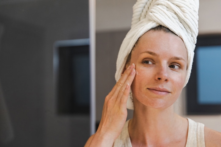 Woman applying face cream