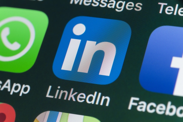 LinkedIn logo on a phone to represent the top 7 LinkedIn trends to watch in 2025