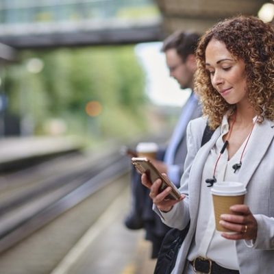 Social media marketing signified by a woman using a phone